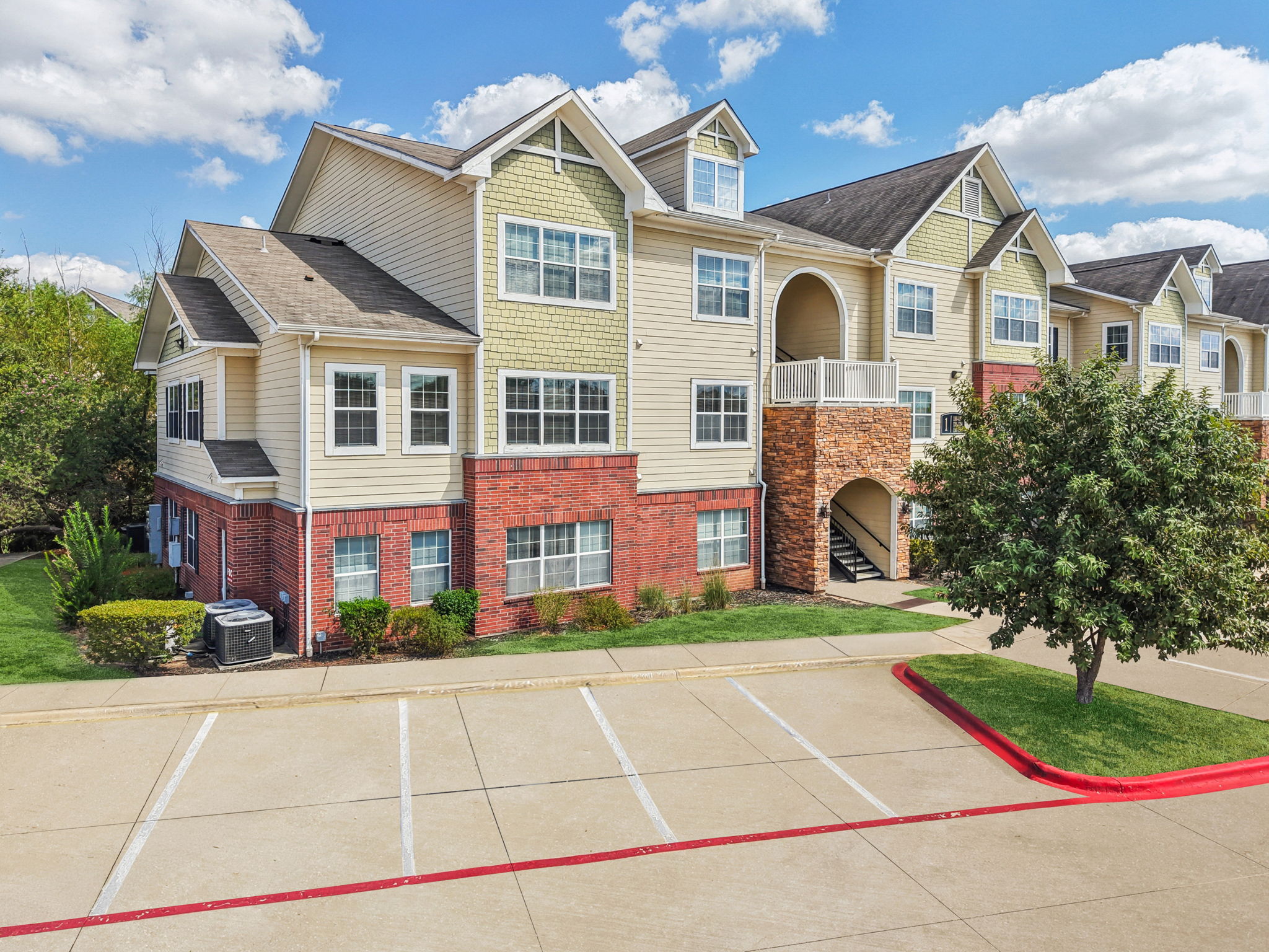 River Valley apartment building exterior with parking and landscaping — Austin, TX