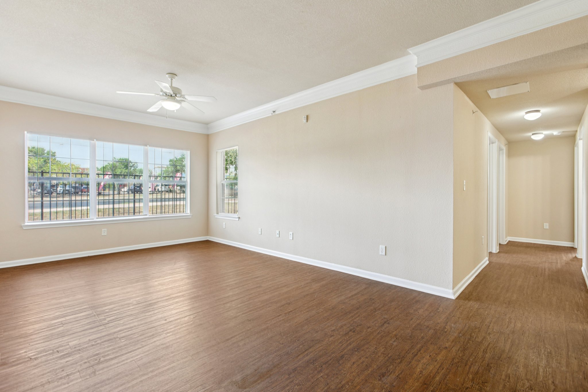 River Valley living room with bay window and wood-look floors — Austin, TX